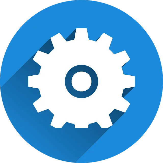 Engranaje blanco sobre fondo azul — Mantenimiento y optimización de páginas webs Icono circular azul con un engranaje blanco y sombra larga que simboliza Mantenimiento y optimización de páginas webs y representa ajustes, soporte técnico y mejora del rendimiento.