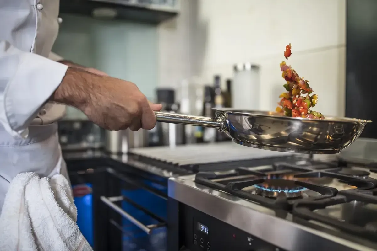chef-holding-frying-pan-cooking
