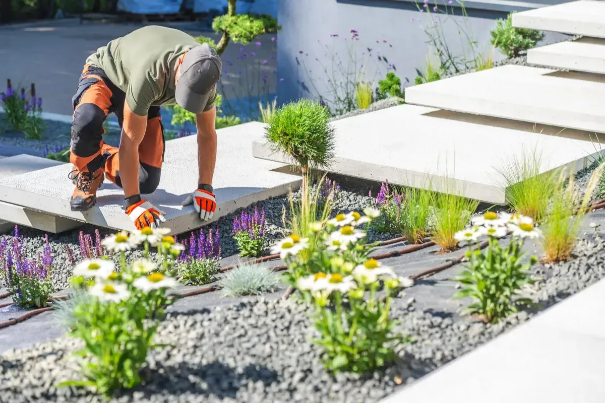 gardener-planting-flowers-in-a-modern-landscape