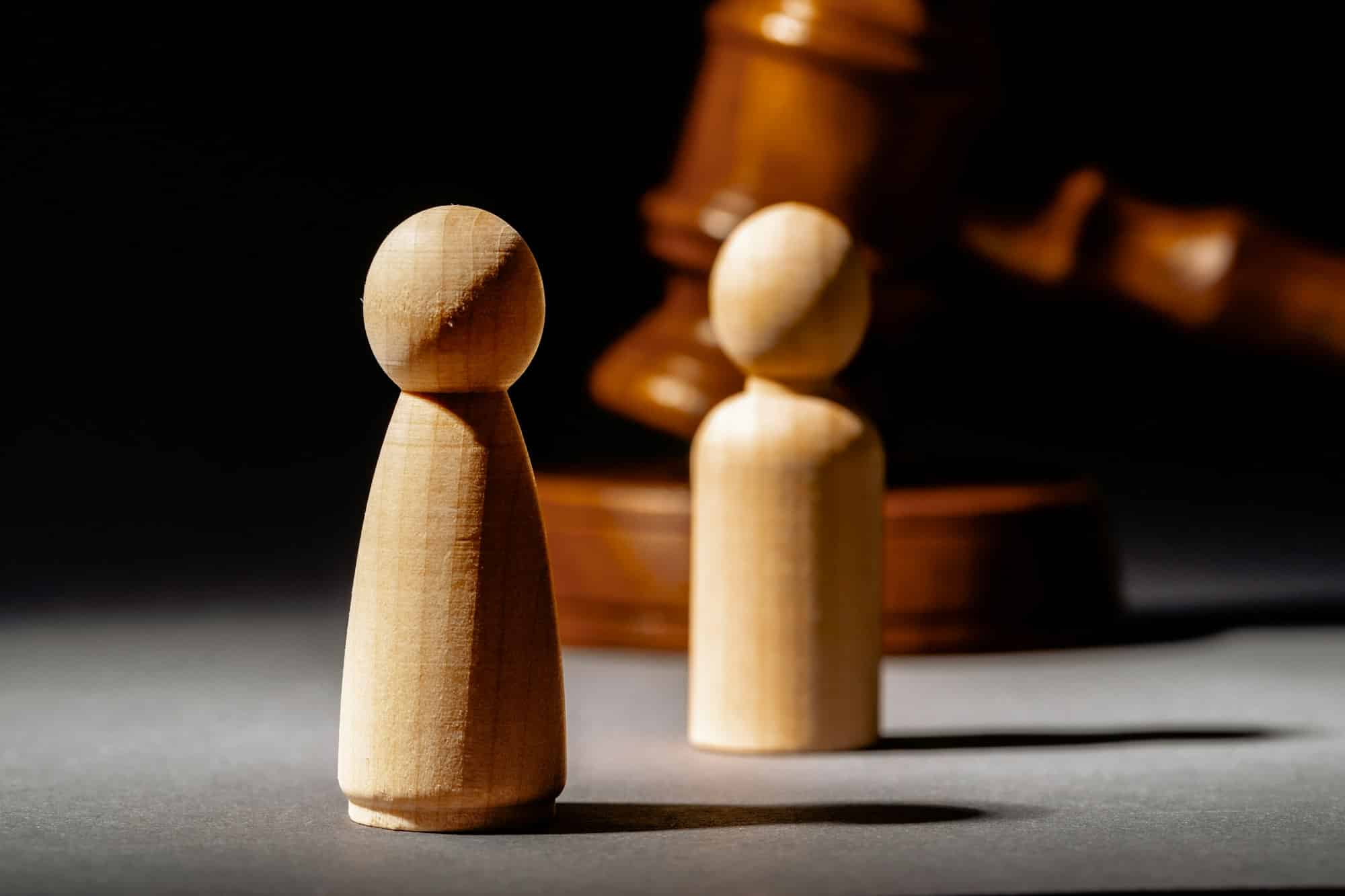 Wooden toy family and judge mallet. Family divorce concept