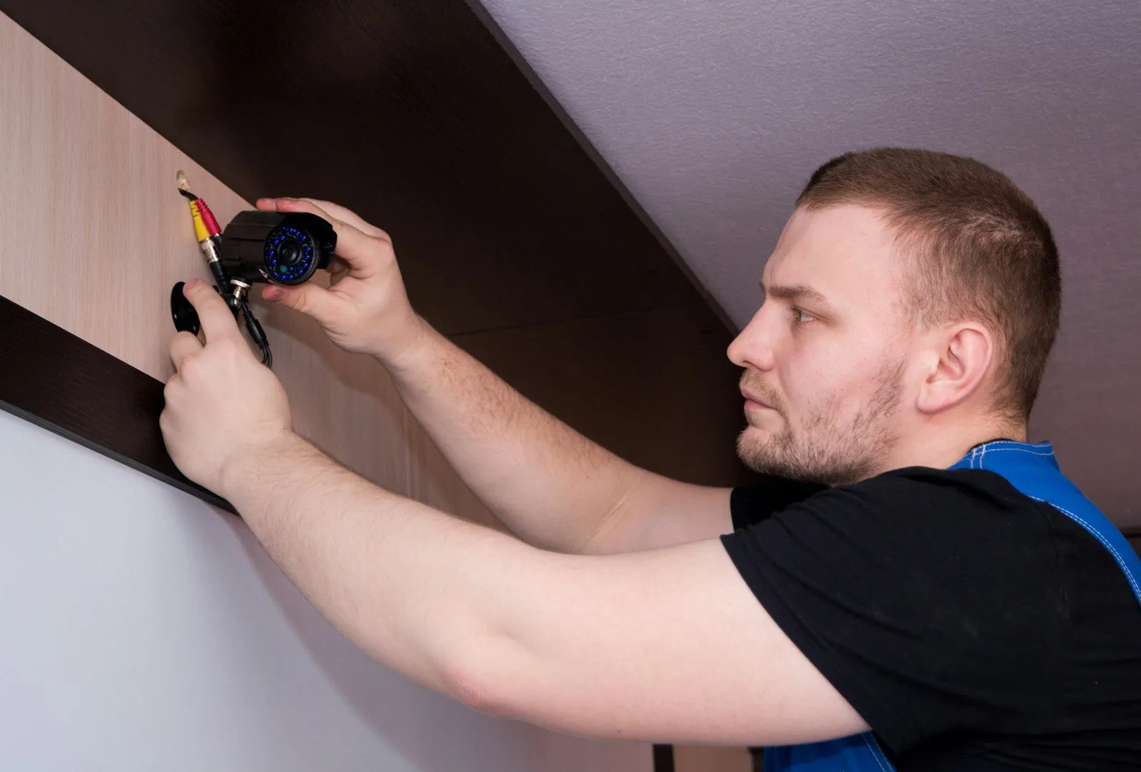 Un employé d'Ax-IT installant une caméra de vidéo surveillance