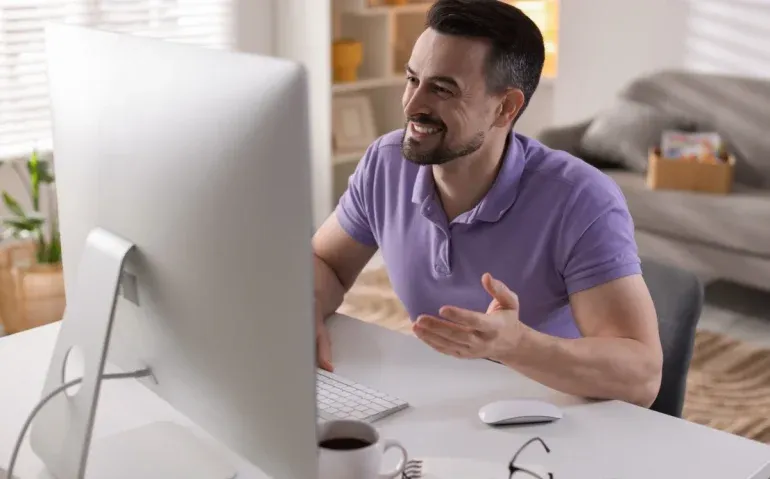 happy-man-having-videochat-by-computer
