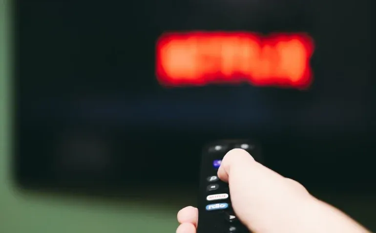 woman-using-remote-control-to-switch