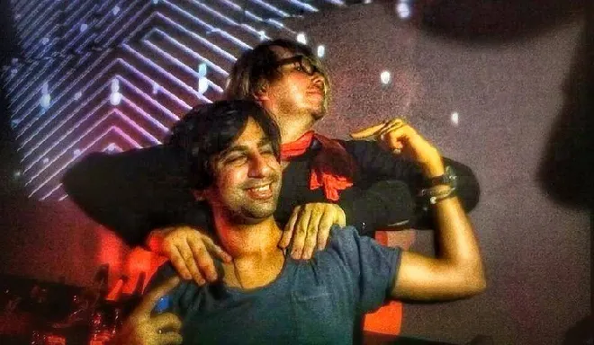 Photograph of Robert Babacz and Guy J getting down