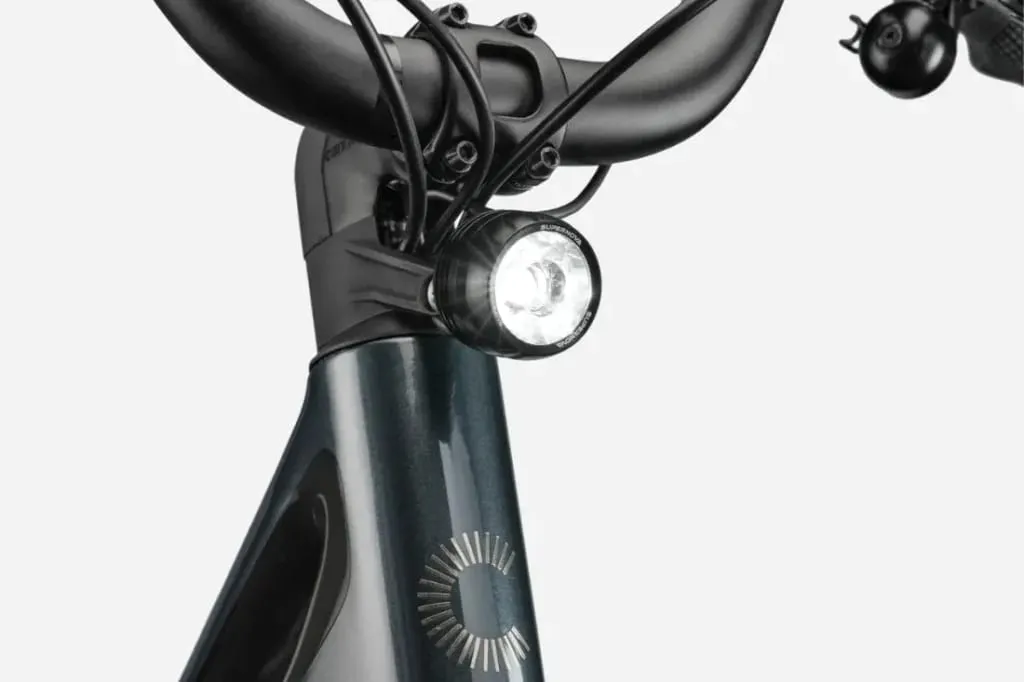 Primer plano de un manillar de bicicleta Cannondale FlyingV con la luz delantera encendida y los cables visibles.