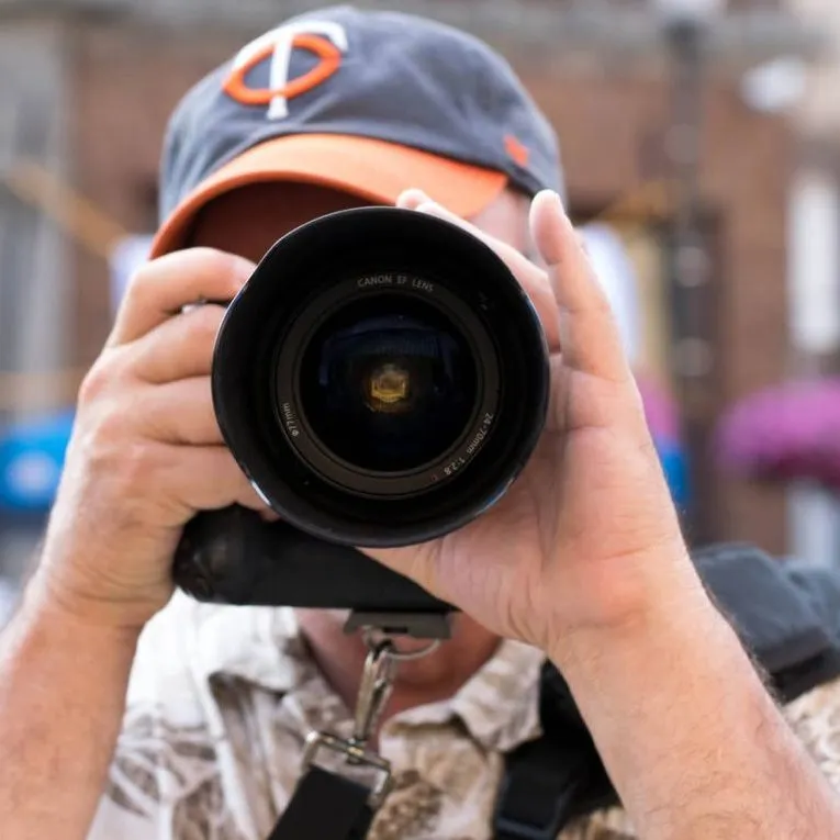 Person photographing with a Canon camera outdoors.