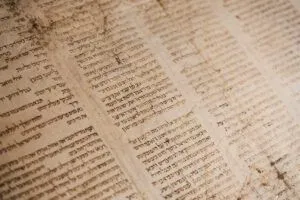 Close-up of an aged Hebrew manuscript with columns of script illustrating Why the Bible's Original Languages of Aramaic, Greek, and Hebrew Matter for Understanding Its Message.