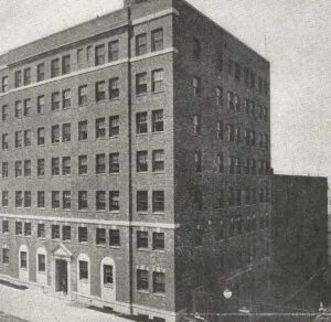 Historic multi-story brick building with rows of rectangular windows and a central arched entrance — What Does Betel Bible Mean? Discover Its Meaning Here!