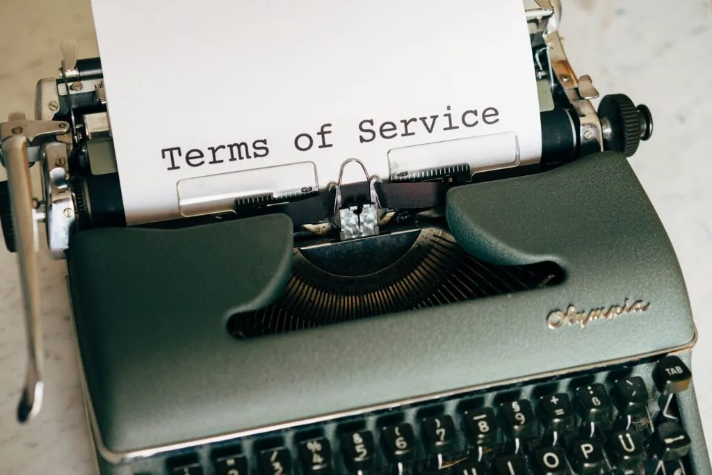 Terms and Conditions document being typed on a vintage Olympia typewriter, representing the legal terms for using Daniel Sandler CPA services