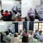 A man gives a presentation to a seated audience in a room with a projector screen and banners, captured from multiple angles.