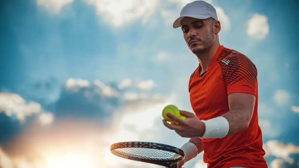 Ready to serve.Young man playing tennis.Full concentration.