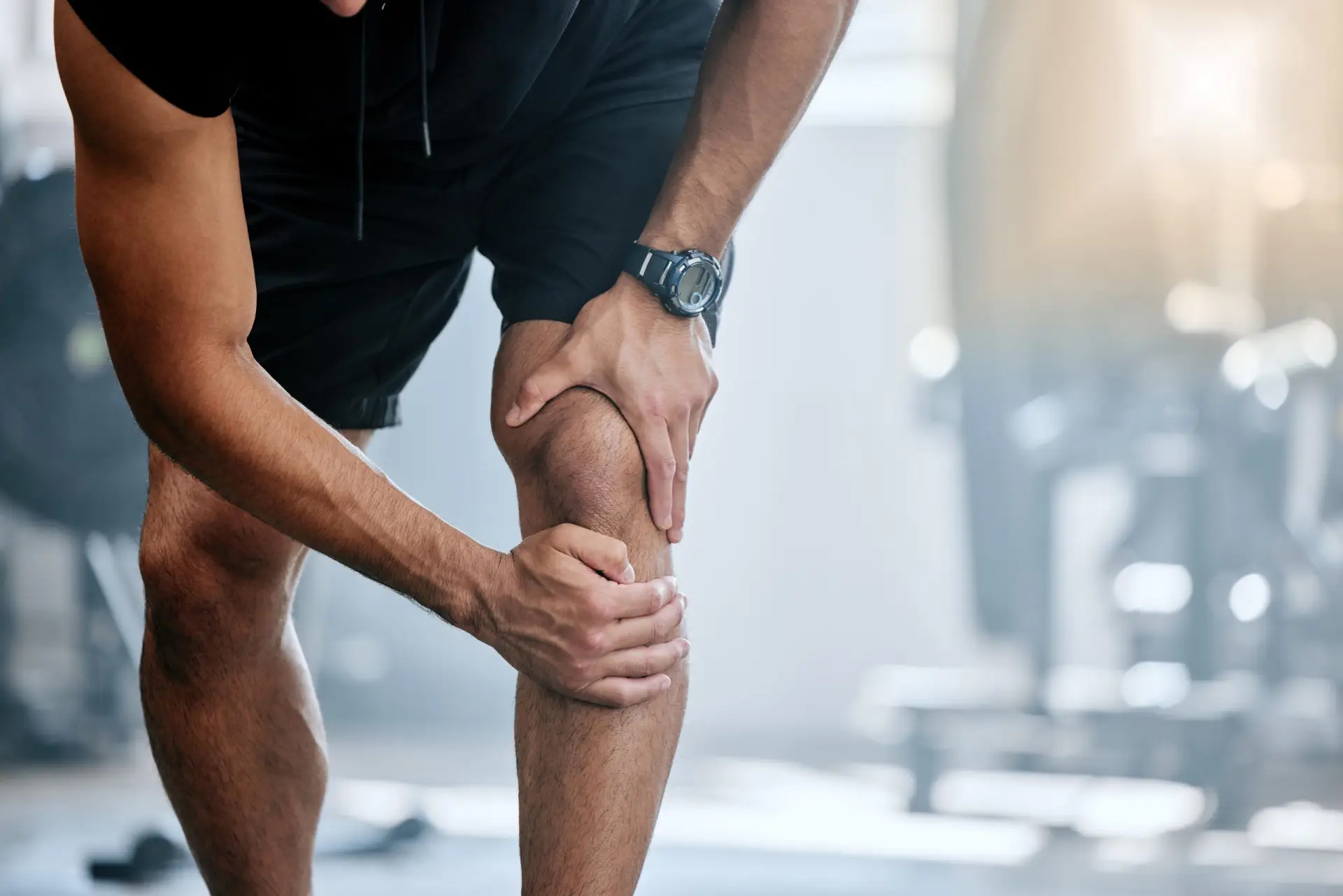 Man holding an injured knee