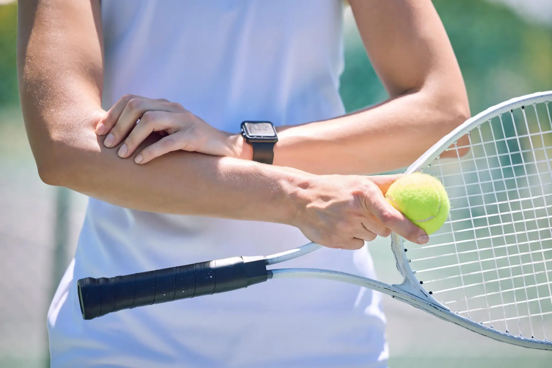 Tennis player holding a painful elbow