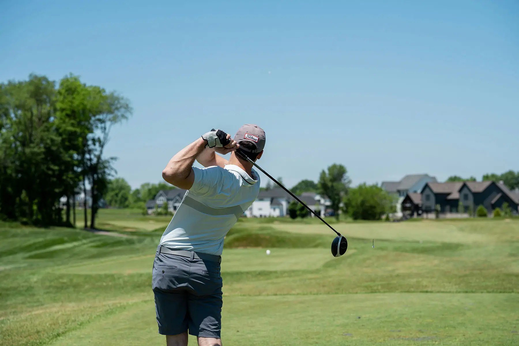 Golfer swinging on a course