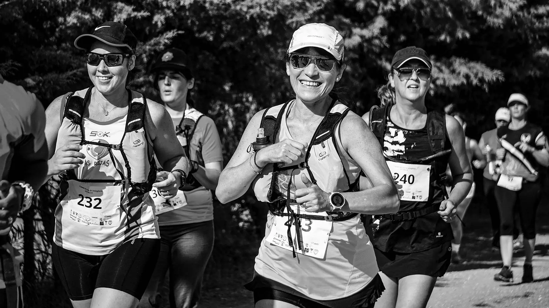 Smiling female runners competing in an outdoor race