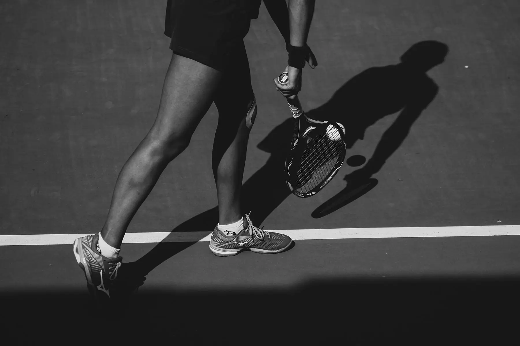 Tennis player holding a racket and ball