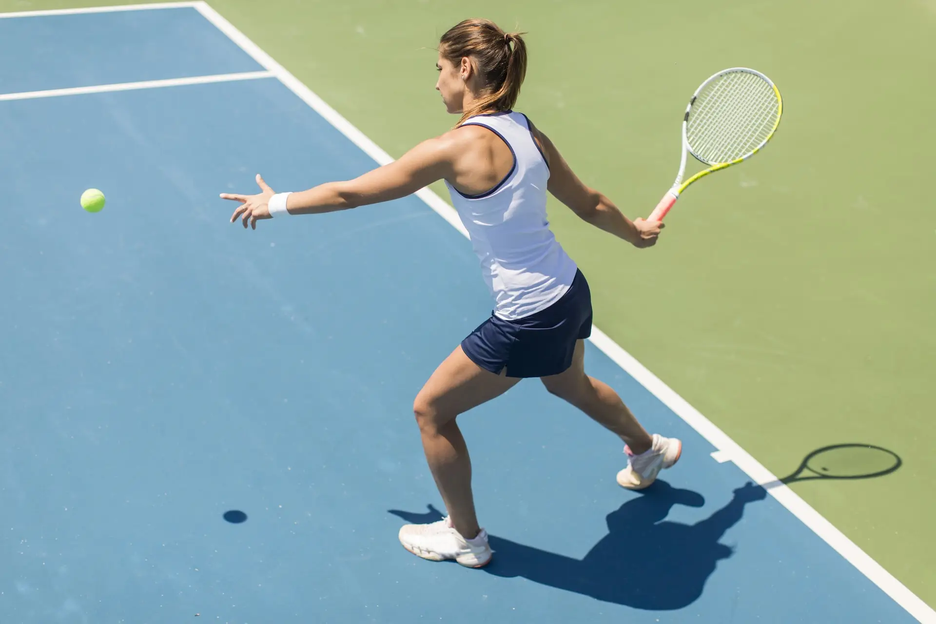 Tennis player holding a racket and ball