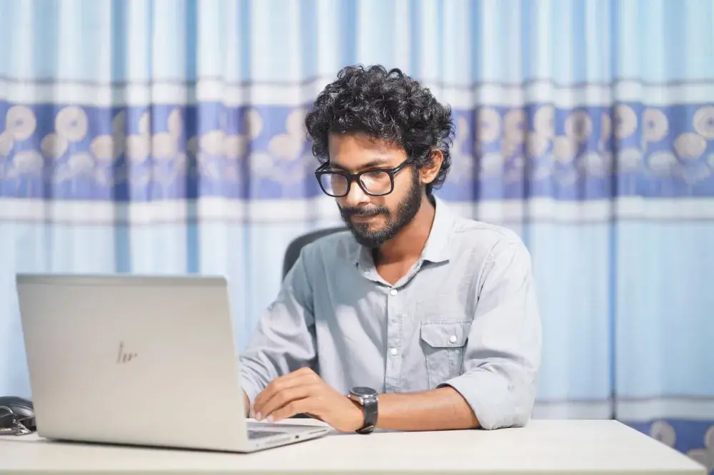 Web designer building a WordPress site on a laptop in a modern Dubai office