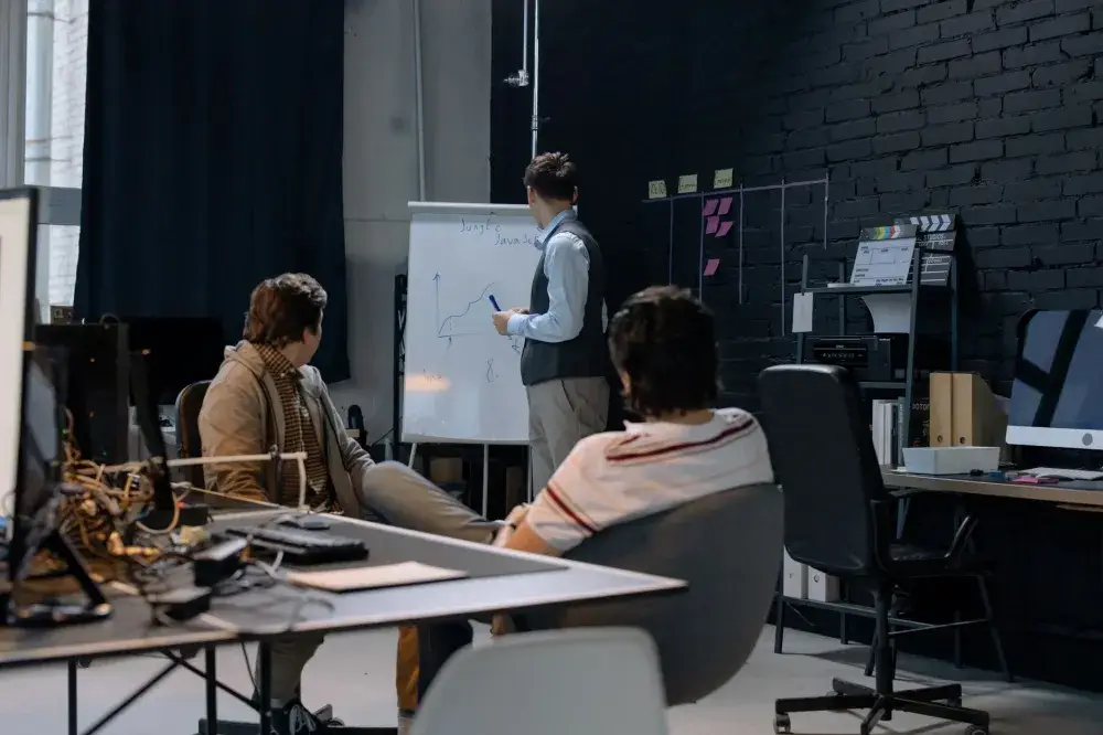 Business team reviewing cybersecurity policy on laptops in a modern Dubai office