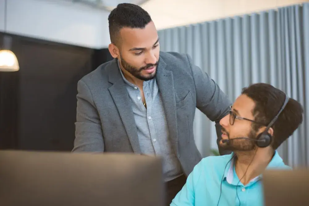 IT support engineer assisting a business owner with firewall setup in Dubai Investment Park