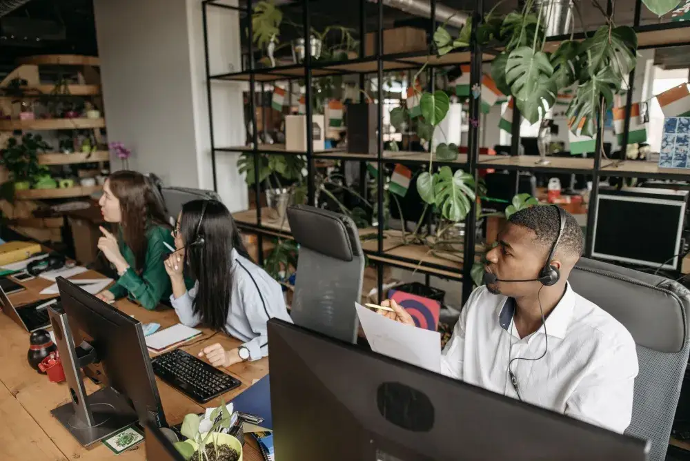 Office team working on computers maintained under an IT AMC support plan in Dubai
