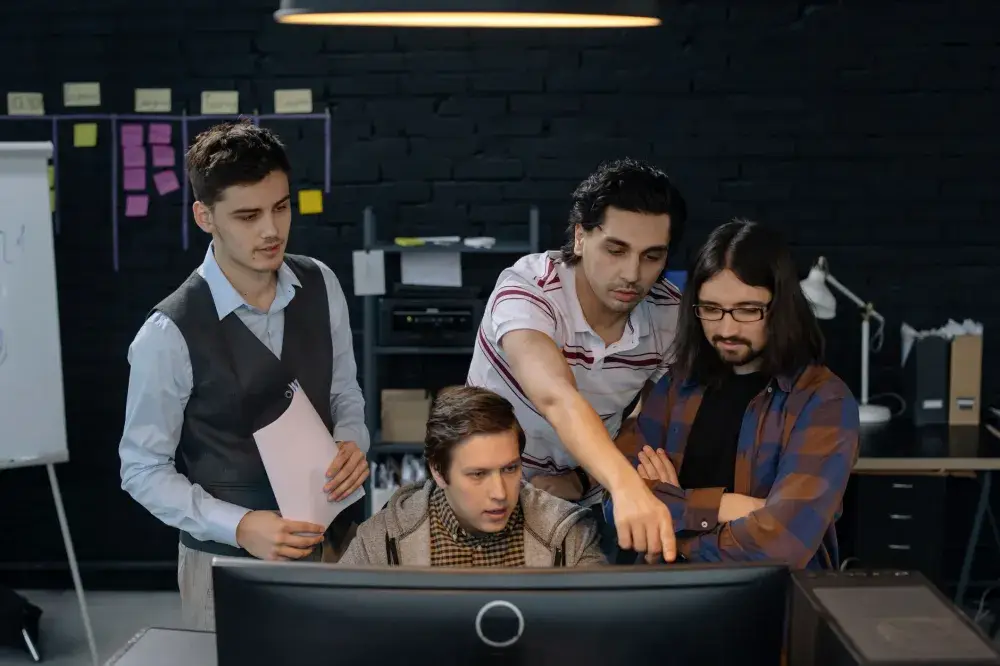 Office team collaborating using Microsoft Teams and SharePoint in a modern workspace