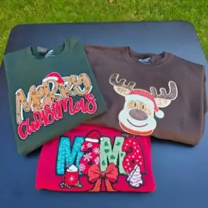 Three sequined Christmas sweatshirts: green "Merry Christmas", brown reindeer, red "MAMA".