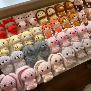 Numerous small, soft, colorful crocheted animals: lions, tigers, pigs, bunnies, bears, giraffes.