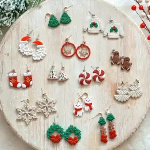 Handcrafted Christmas earrings on wood: Santa, trees, sweaters, gingerbread, candy canes, snowflakes, wreaths.