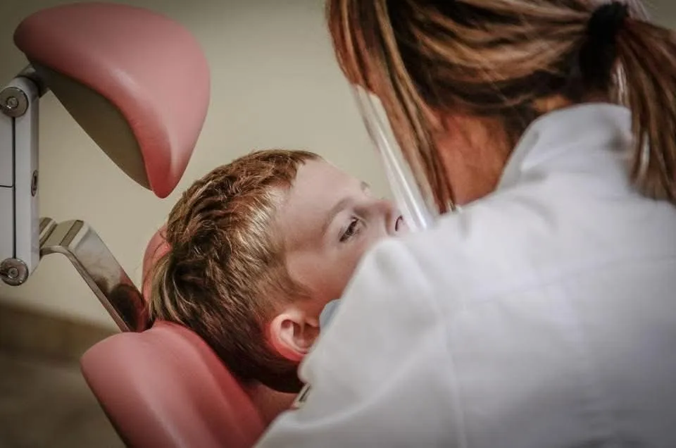 Patient being examined by a dentist; a tooth infection needs professional treatment