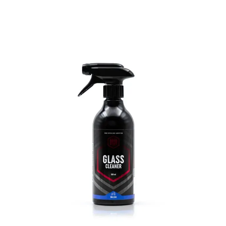 A black spray bottle labeled Glass Cleaner with a hexagonal design and blue accent, standing upright on a white background. This streak-free cleaner ensures spotless, gleaming surfaces every time.