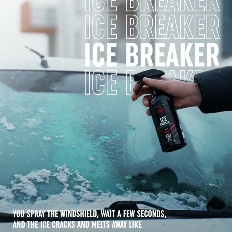 A person sprays Good Stuff Ice Breaker de-icer onto a snow-covered windshield; large text reads ICE BREAKER and smaller text describes how this winter pre-wash easily melts ice without scraping.