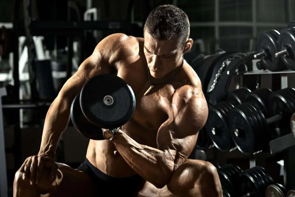 very power athletic guy bodybuilder , execute exercise with dumbbells