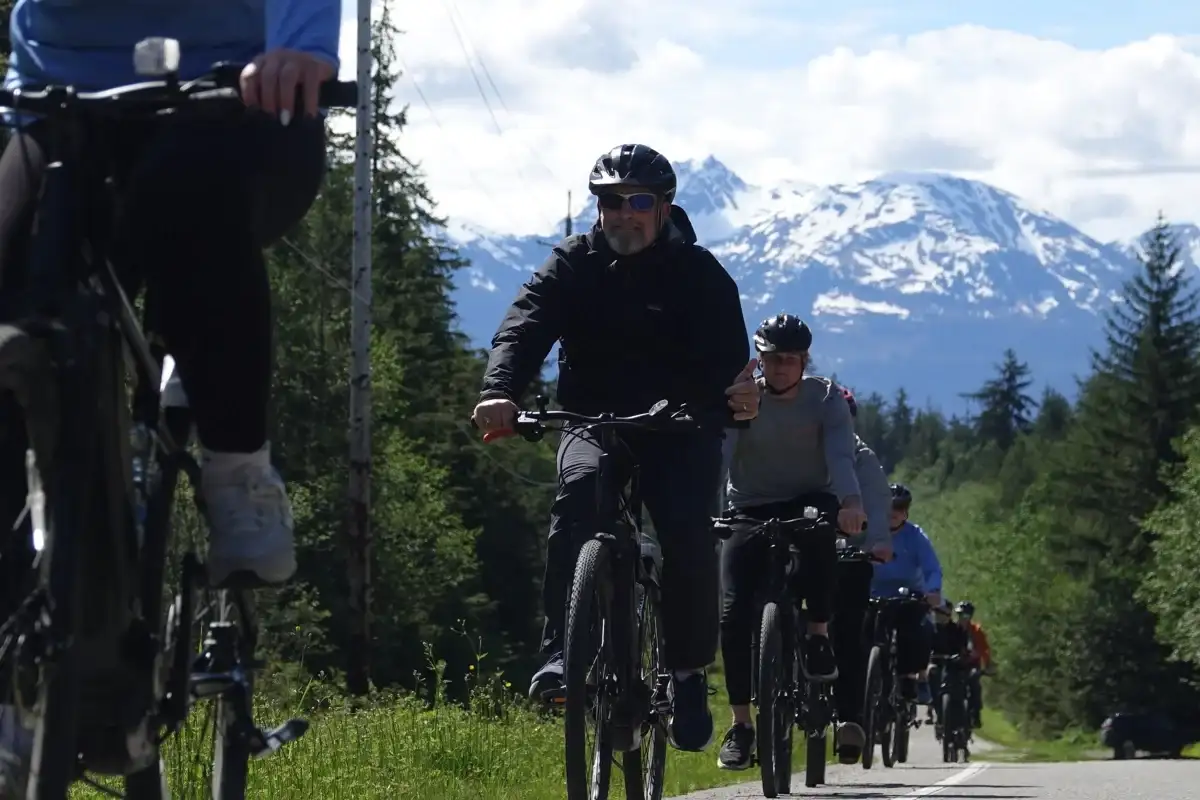 Top 10 Alaskan Tours You Can’t Miss: A Complete Guide for Travelers 2 Group of riders on an eBike tour with snow-capped Juneau Alaska mountains.