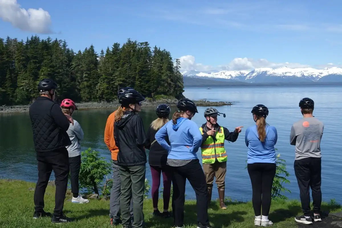 Top 10 Alaskan Tours You Can’t Miss: A Complete Guide for Travelers 4 iRide Alaska guide points out Juneau coastal scenery and mountains to a helmeted tour group.