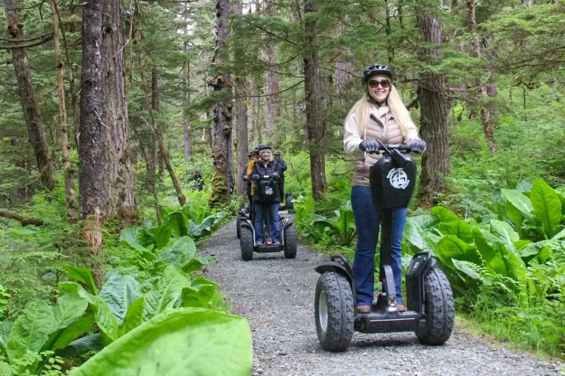 Juneau-alpine-segway-rainforest-small-group-smile-fun-1200x800 Group enjoys a Juneau Segway tour on a lush rainforest trail.