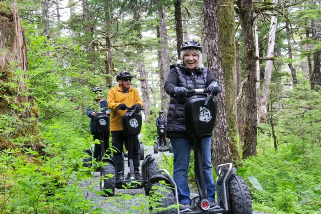 Segway Tour Requirements: Weight, Age & Safety | iRide Alaska 1 Smiling guests on an iRide Alaska Juneau Segway tour in a lush rainforest.