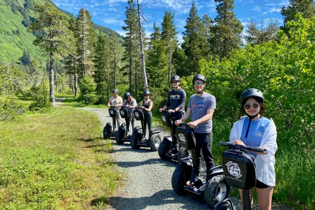 Six guests on an iRide Alaska Segway tour through a Juneau forest.