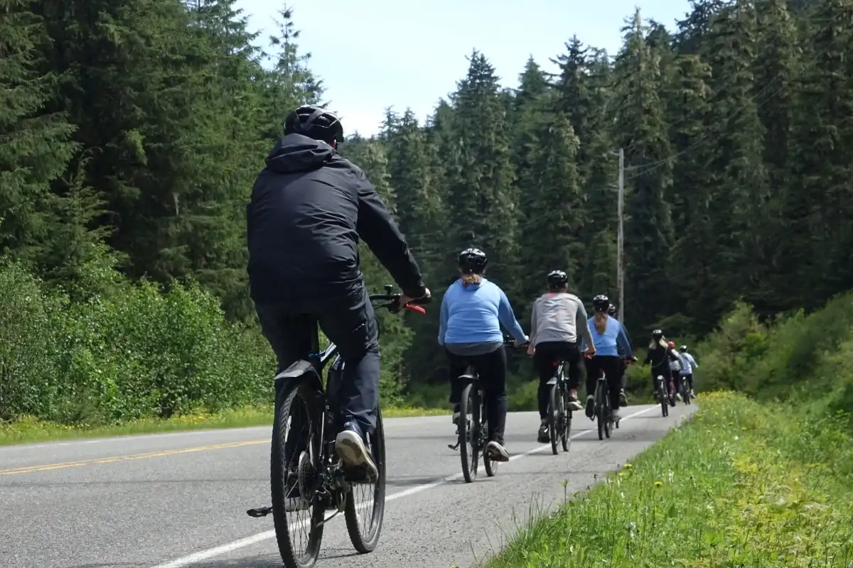Juneau-rainforest-ebike-forest-view-nature-group-1200x800 Group on an iRide Alaska eBike tour cycling a paved road through Juneau's coastal rainforest.
