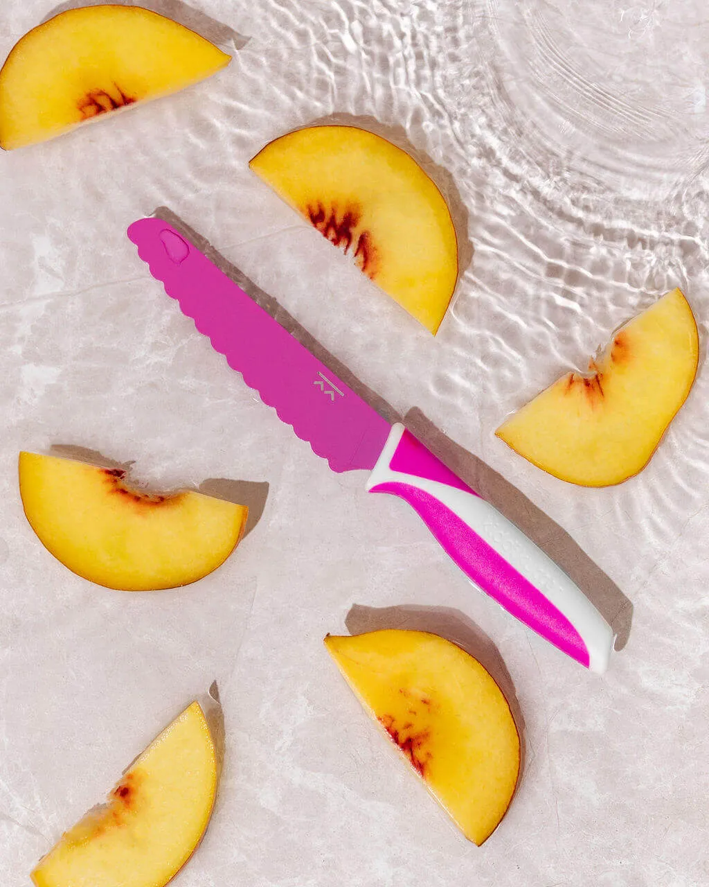 Pink KiddiKutter with sliced peaches