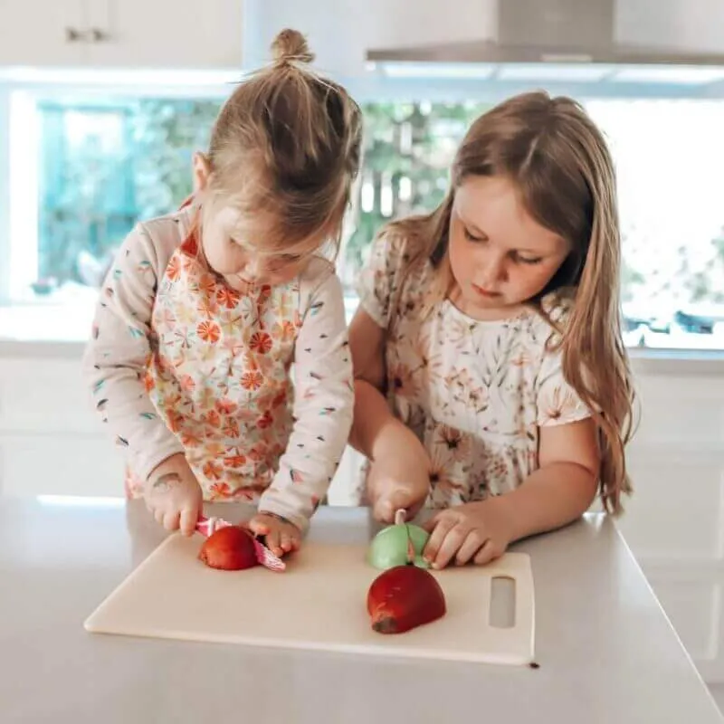 two girls preparing fruit with kiddikutter knives