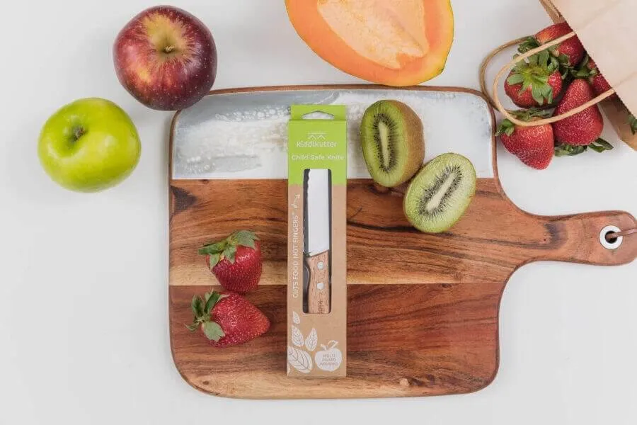 kids safe knife in packaging on chopping board