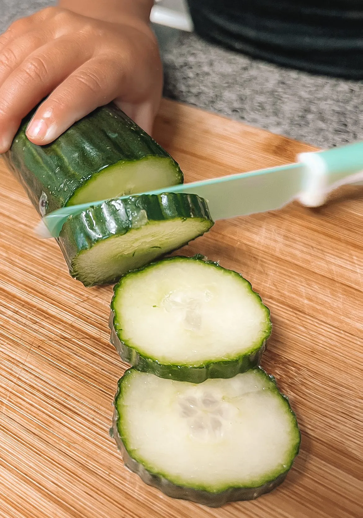 Sea Green KiddiKutter slicing cucumber
