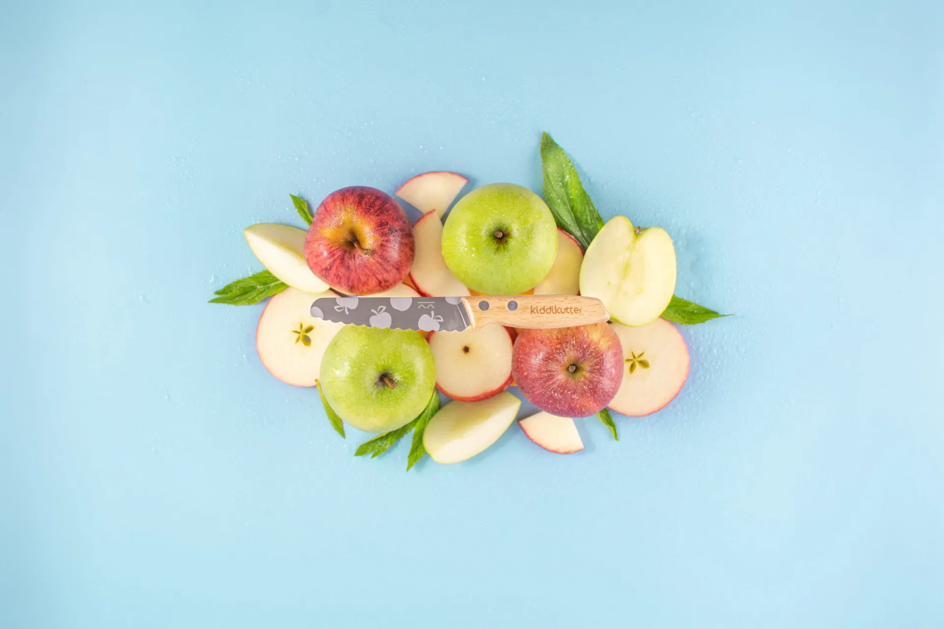 Fresh apples and fruit on a blue background