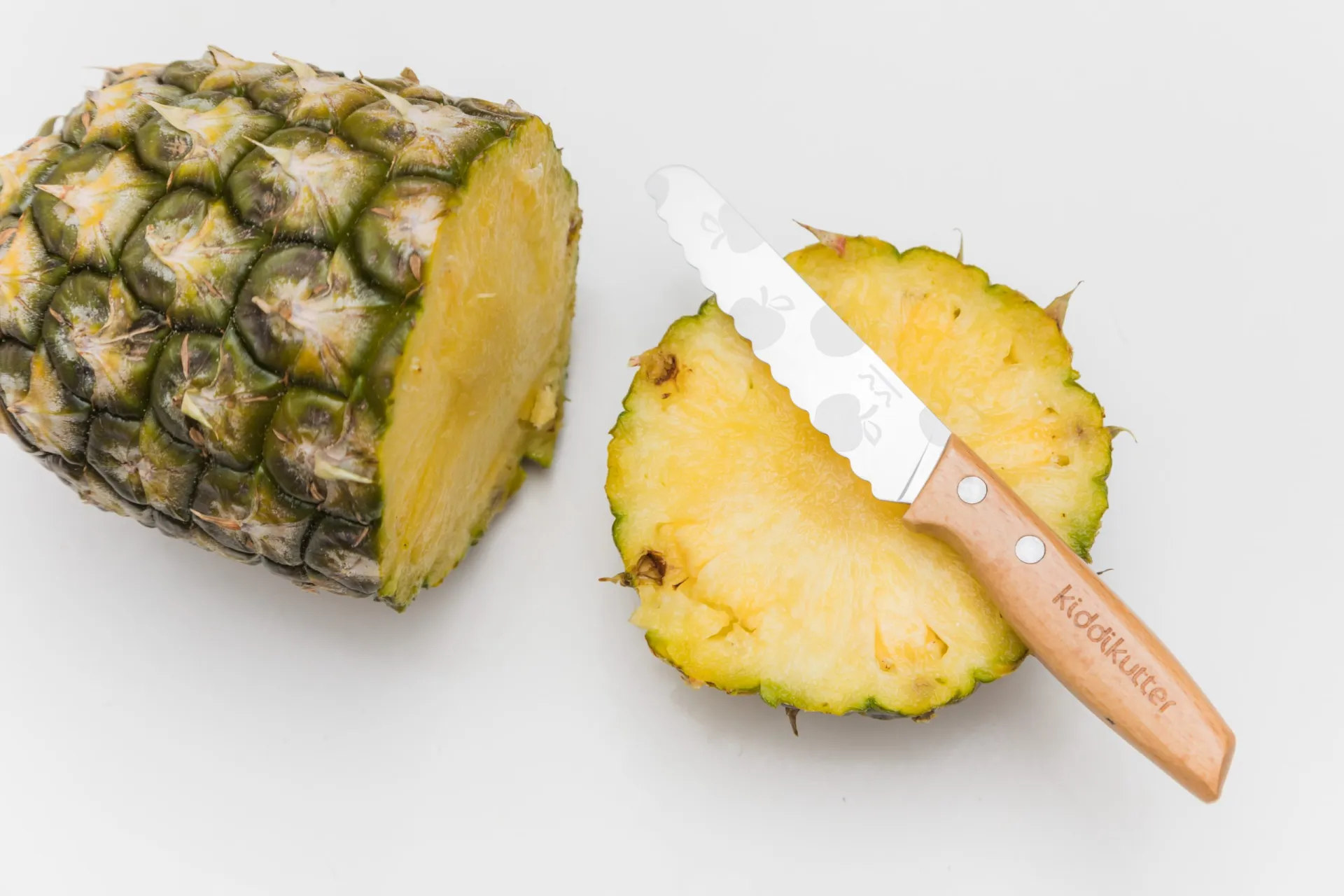 Wooden KiddiKutter cutting pineapple