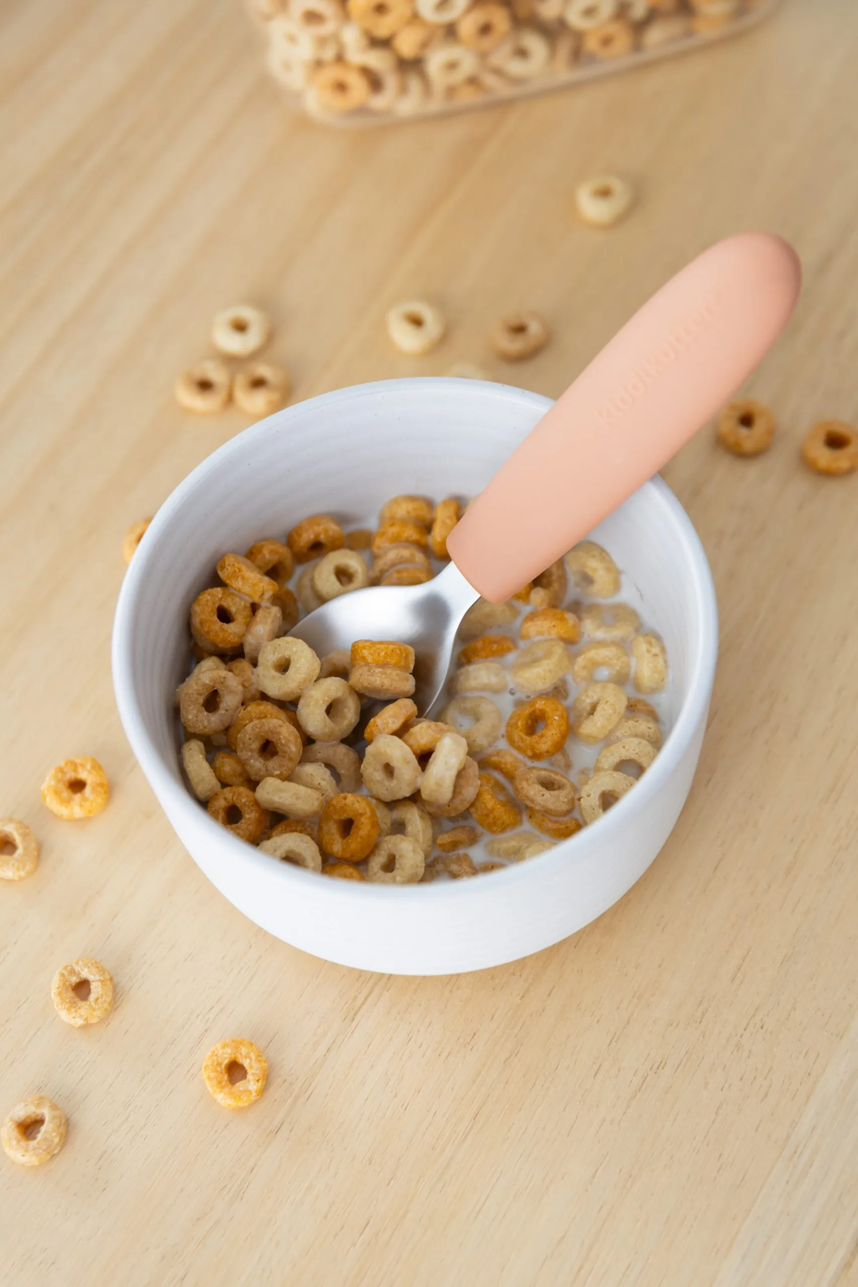Kids spoon in a bowl of cereal