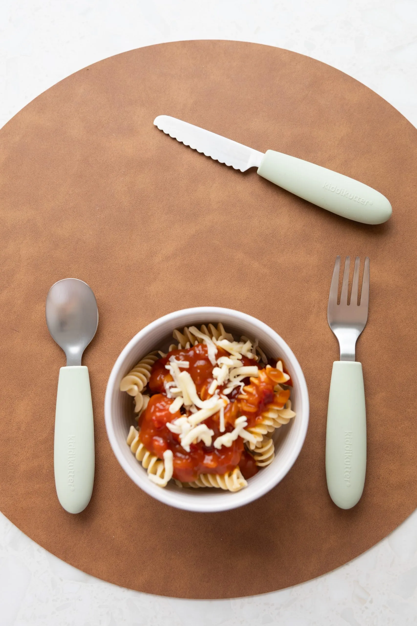 Sage kids cutlery with a bowl of pasta