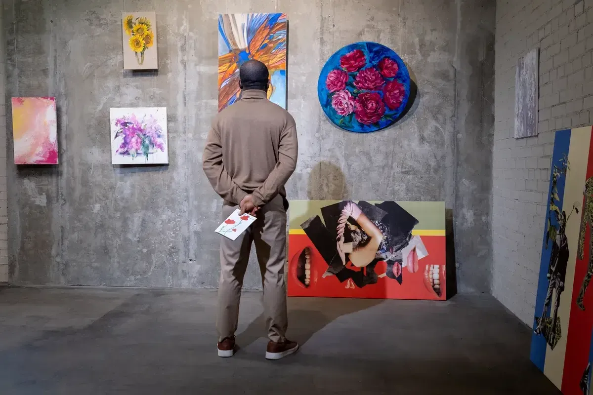 man-looking-at-modern-paintings