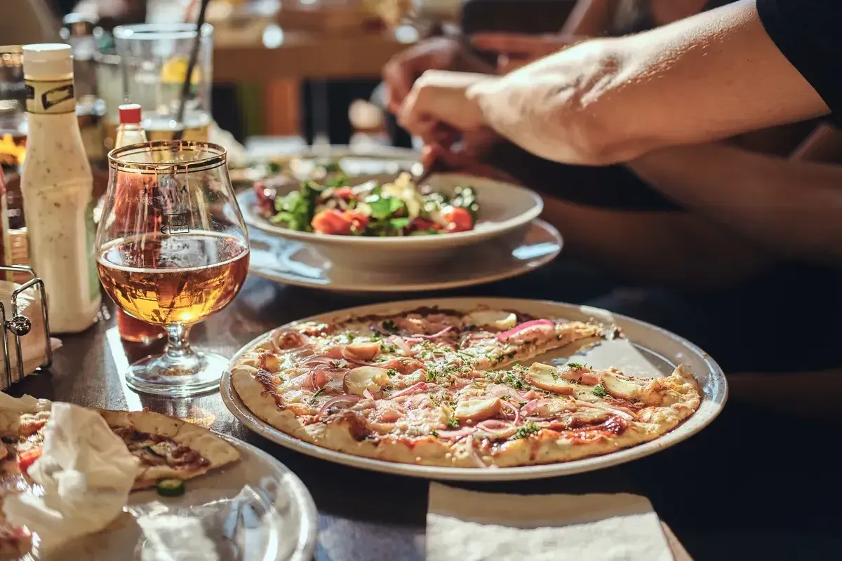 young-friends-students-eat-pizza-and-salads