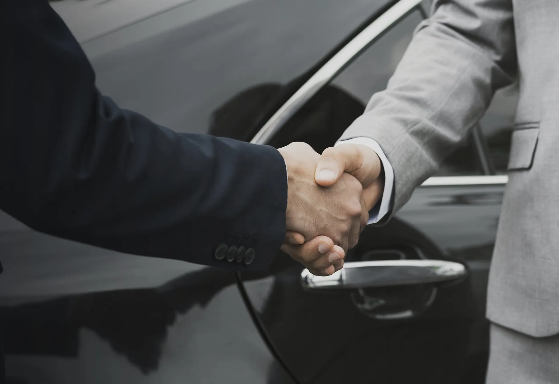 Businessmen greeting by shaking hands